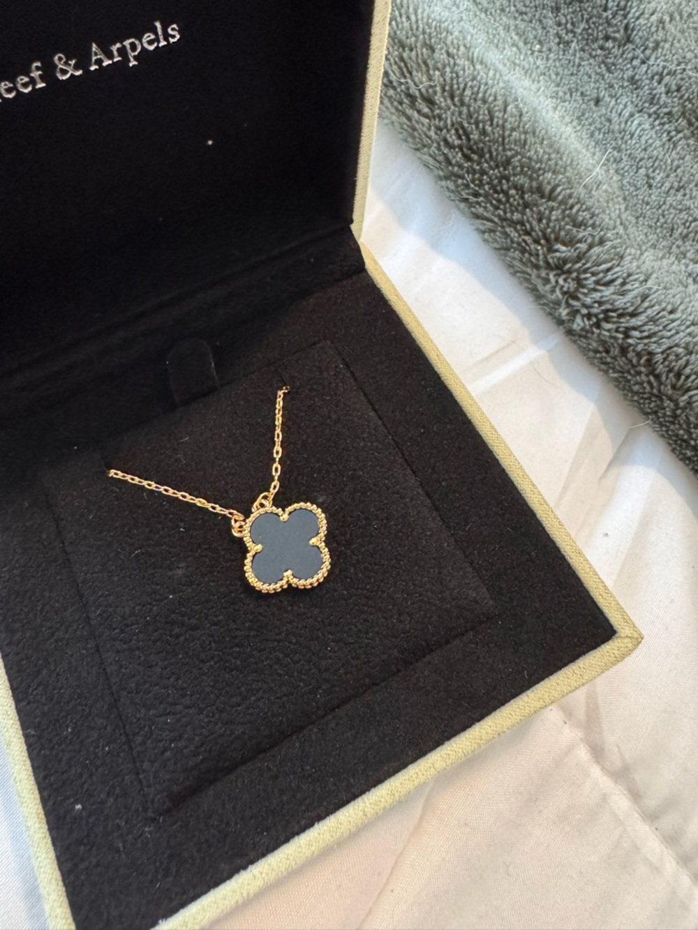 Clover motif black and gold necklace